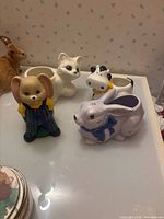 Group shot of four ceramic animal pieces