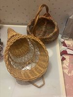 Cone wall pocket beside round basket on surface