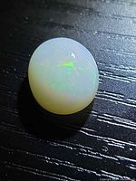 Front view of oval cabochon opal showing play-of-color