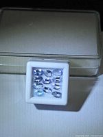 Front view of boxed lot showing all oval tanzanites