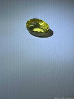 Faceted oval yellow gemstone top view