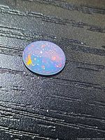 Obverse view of opal showing strong multicolour pinfire pattern
