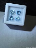 Four light blue pear-cut aquamarines in white gem box