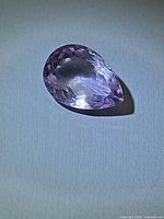 Pear-cut pink purple amethyst, top view under light