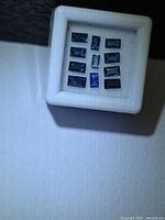Lot of eleven rectangular blue sapphires in display box