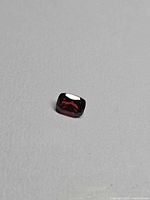 Front view of loose cushion cut red garnet