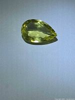 Pear-shaped lemon citrine on neutral background