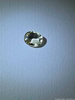 Top view of oval golden yellow scapolite