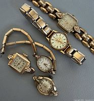 All five gold-tone women’s wristwatches grouped