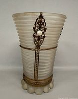 Front view of ribbed frosted glass vase with metal filigree and faux pearl accent
