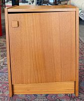 Front view of teak bedside cabinet with closed door