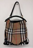 Front view of Burberry Nova Check canvas hobo with leather trim and straps