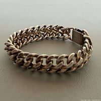 Bracelet standing showing double curb links and clasp