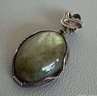 Front view showing labradorite cabochon and silver wire setting