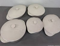 Top view of five lidded Calphalon stoneware casseroles