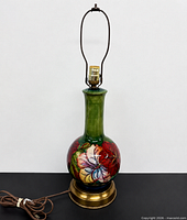 Full view of Moorcroft Hibiscus ceramic lamp with harp, cord and brass base