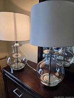 Both lamps on dresser showing full view with shades