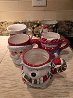 All five ceramic Christmas mugs grouped