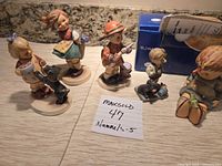 All five Hummel figurines with box visible