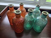 Front view of all six bottle candle holders on tray