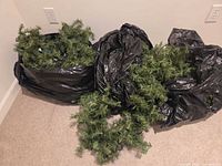 Three bags containing artificial evergreen garland
