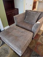Armchair and ottoman together showing overall style and color