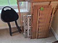 Stool, wooden gate, two plastic gates leaning together