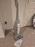 Full view of upright Hoover FloorMate cleaner standing on carpet