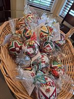 Basket containing numerous cello-wrapped handmade fabric Christmas ornaments