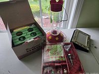 All items grouped: condiment holder box, hummingbird feeder, holiday entertaining set, photo frame