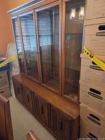Full view of cabinet showing glass upper doors and wooden base