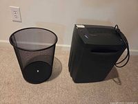 Paper shredder and mesh wastebasket side by side