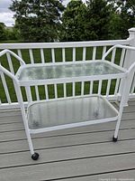 Full view of bar cart showing two glass shelves and metal frame