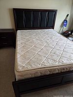 Full view of assembled queen bed frame with mattress