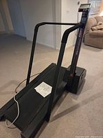 Full view of treadmill with manual on belt