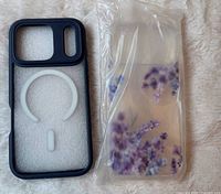 Dark blue MagSafe case beside packaged clear floral case