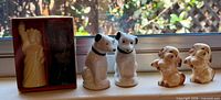 All six shakers: packaged Statue of Liberty pair, RCA Nipper pair, light brown spaniel pair