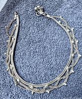 Full view of anklet laid flat showing overall design and condition