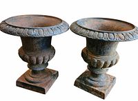 Front view of both cast iron urns showing shape and bases