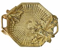 Top view of brass octagonal tray showing leaf and berry relief and handles