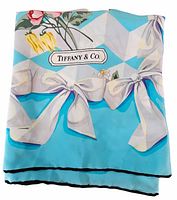 Folded scarf showing Tiffany & Co. logo, bow border and turquoise background