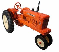 Left front three-quarter view of orange diecast tractor