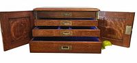 Chest with doors open showing four fitted drawers