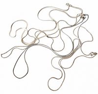 Group of four sterling chains loosely coiled