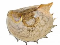 Top view of conch shell art glass bowl showing interior well, crackle pattern and applied ridge points