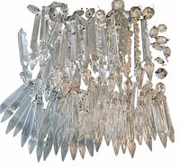 Group of assorted clear crystal prisms laid out in rows