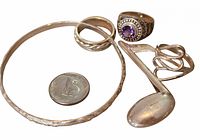 overview of all sterling items including bangle, rings, spoon, coin for scale