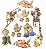 Group shot of all seven pendants showing designs and two chains
