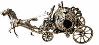Full side view of silver miniature horse pulling ornate pumpkin carriage