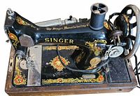 Full view of Singer sewing machine showing decals, base, attached motor